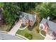 Two-story brick home on landscaped lawn, nestled among mature trees in established neighborhood at 1612 Branch Creek Cv, Lawrenceville, GA 30043