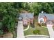 Charming two-story home with a brick facade, lush landscaping, and a long driveway at 1612 Branch Creek Cv, Lawrenceville, GA 30043