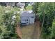 View of back of home with deck and fenced yard surrounded by mature trees offering privacy at 1612 Branch Creek Cv, Lawrenceville, GA 30043
