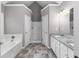 Bright bathroom with tub and separate shower with a double vanity and granite countertops at 1612 Branch Creek Cv, Lawrenceville, GA 30043