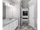 Bright bathroom with double vanity, shower, granite countertops, and neutral color scheme at 1612 Branch Creek Cv, Lawrenceville, GA 30043