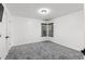 Bright empty bedroom with plush carpeting and a window at 1612 Branch Creek Cv, Lawrenceville, GA 30043