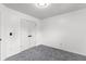 Empty bedroom featuring a double closet and plush carpeting at 1612 Branch Creek Cv, Lawrenceville, GA 30043