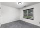 Neutral bedroom features a window and plush carpeting at 1612 Branch Creek Cv, Lawrenceville, GA 30043