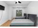Bright bedroom with two twin beds, a window, and wood flooring at 1612 Branch Creek Cv, Lawrenceville, GA 30043