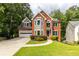Charming two-story brick home with a well-manicured front lawn and attached two-car garage at 1612 Branch Creek Cv, Lawrenceville, GA 30043