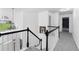 Upstairs hallway with black and white banister, fresh paint, and new carpeting at 1612 Branch Creek Cv, Lawrenceville, GA 30043
