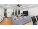 Open living space with a large gray sectional sofa, a view of the dining area and access to the balcony at 1612 Branch Creek Cv, Lawrenceville, GA 30043