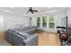 Spacious living room with a comfortable gray sectional sofa and scenic views through large windows at 1612 Branch Creek Cv, Lawrenceville, GA 30043