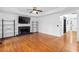 Cozy living room with hardwood floors, fireplace, and natural light at 1612 Branch Creek Cv, Lawrenceville, GA 30043