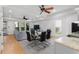 Open living space with modern furnishings, ceiling fans, natural light, and kitchen/dining area at 1612 Branch Creek Cv, Lawrenceville, GA 30043