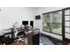 Home office with a large window, a desk, and a neutral color scheme at 1612 Branch Creek Cv, Lawrenceville, GA 30043