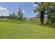 Spacious green backyard bordered by trees and landscaping, offering privacy and a natural setting at 3411 Morgan Rd, Canton, GA 30115