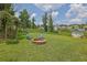 Fire pit with chairs, a swing, and shed with a grassy backyard at 3411 Morgan Rd, Canton, GA 30115