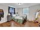 Cozy bedroom with hardwood floors, large window, and stylish decor at 3411 Morgan Rd, Canton, GA 30115