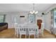 Bright dining area with a stylish chandelier, comfortable seating, and a view into the living room at 3411 Morgan Rd, Canton, GA 30115