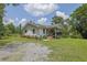 Inviting home exterior with a cozy covered porch, complemented by vibrant flowers and a well-maintained lawn at 3411 Morgan Rd, Canton, GA 30115