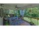 Charming covered porch featuring comfortable seating, stylish decor, and a ceiling fan for outdoor enjoyment at 3411 Morgan Rd, Canton, GA 30115