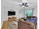 Comfortable living room features hardwood floors, a large TV, and plush seating for relaxing and entertaining at 3411 Morgan Rd, Canton, GA 30115