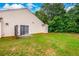 A large backyard area with green grass and sliding glass doors at 455 Lakeside Cir, Covington, GA 30016