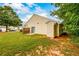 A well-maintained backyard with green grass and a small patio at 455 Lakeside Cir, Covington, GA 30016