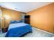 Cozy bedroom featuring blue bedding, natural light, and a television for relaxation at 455 Lakeside Cir, Covington, GA 30016