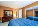 Bedroom featuring a dresser, full-length mirror closet, and doorway at 455 Lakeside Cir, Covington, GA 30016