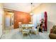 Dining area featuring a chandelier, table with four chairs, and an accent wall at 455 Lakeside Cir, Covington, GA 30016