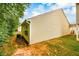 Back of home, displaying siding, small back porch, and well-maintained lawn at 455 Lakeside Cir, Covington, GA 30016
