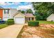 Charming home featuring an attached garage, lawn, and curb appeal at 455 Lakeside Cir, Covington, GA 30016