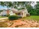 Charming home with a well-manicured front yard, garden, and attached garage at 455 Lakeside Cir, Covington, GA 30016