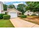 Charming home with a well-manicured front yard, driveway, and attached garage at 455 Lakeside Cir, Covington, GA 30016