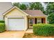 Charming home featuring a one-car garage, well-maintained landscaping, and inviting front entrance at 455 Lakeside Cir, Covington, GA 30016