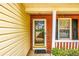 Close-up view of the front porch with brick accents, a glass door, and a neatly kept welcome mat at 455 Lakeside Cir, Covington, GA 30016