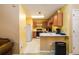 View of the kitchen with white appliances, light wood cabinetry, and laminate countertops at 455 Lakeside Cir, Covington, GA 30016