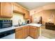 Open-concept kitchen with light wood cabinets, white countertops, and stainless steel appliances at 455 Lakeside Cir, Covington, GA 30016