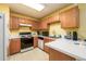 Kitchen featuring wooden cabinets, white countertops, and stainless steel appliances at 455 Lakeside Cir, Covington, GA 30016