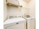 An interior laundry room with a washer, a dryer, and wire shelving provides a dedicated space for laundry tasks at 455 Lakeside Cir, Covington, GA 30016