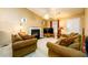 A traditionally decorated living room features a ceiling fan, a television, and a fireplace with a white mantel at 455 Lakeside Cir, Covington, GA 30016