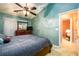 The main bedroom includes an en-suite bathroom, a ceiling fan, and carpeted floors at 455 Lakeside Cir, Covington, GA 30016