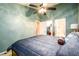 A bedroom with light-green colored walls featuring a walk-in closet and en-suite bathroom at 455 Lakeside Cir, Covington, GA 30016
