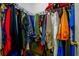A walk-in closet offers ample storage with an array of hanging clothes on racks at 455 Lakeside Cir, Covington, GA 30016