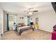 Bedroom featuring carpet, ceiling fan, and natural light from two windows at 647 Sunshine Nw Trce, Acworth, GA 30102