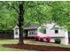 Charming single-Gathering home with a cozy front porch and lush landscaping at 647 Sunshine Nw Trce, Acworth, GA 30102