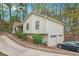 Back exterior of a house with a long driveway and a two car garage at 647 Sunshine Nw Trce, Acworth, GA 30102