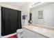 Well-lit bathroom featuring a shower with a black curtain and vanity sink at 7835 Teton Trl, Douglasville, GA 30134