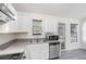 The well-lit kitchen offers stainless steel appliances and granite countertops at 7835 Teton Trl, Douglasville, GA 30134