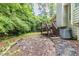 View of the backyard featuring wooden deck stairs and lush green trees at 10 Mariner Se Way, Acworth, GA 30102
