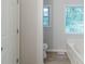 A bright bathroom featuring a white soaking tub and views of the surrounding trees at 10 Mariner Se Way, Acworth, GA 30102