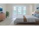 This staged bedroom has a bay window, side table, lamp, dresser, and a houseplant at 10 Mariner Se Way, Acworth, GA 30102